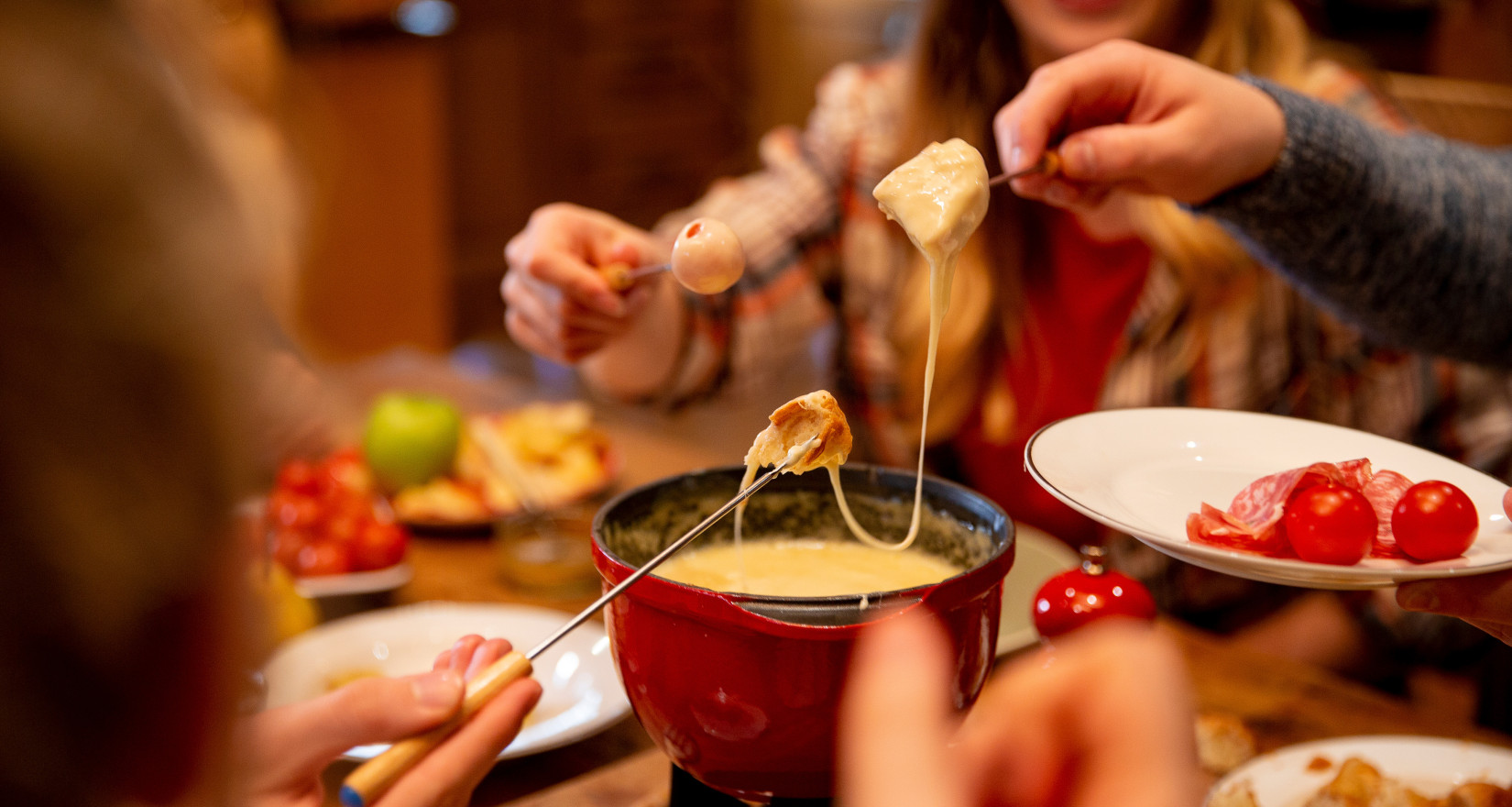 People eating cheese fondue