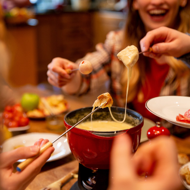 People eating cheese fondue 