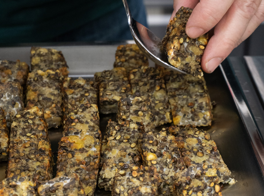 Vegetarische Quadrate werden von Hand auf einem Blech angerichtet