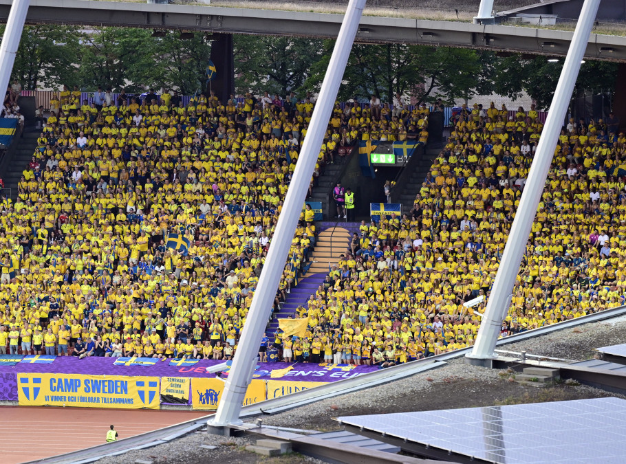 Stadion bei einem Fussballspiel mit Fans in gelben Trikots