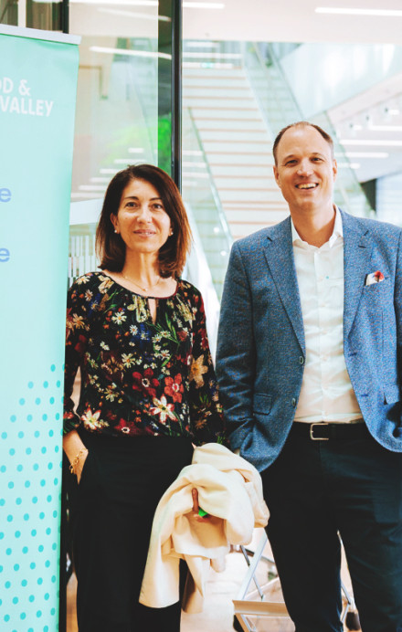 Drei Personen stehen vor einem Banner von SFNV